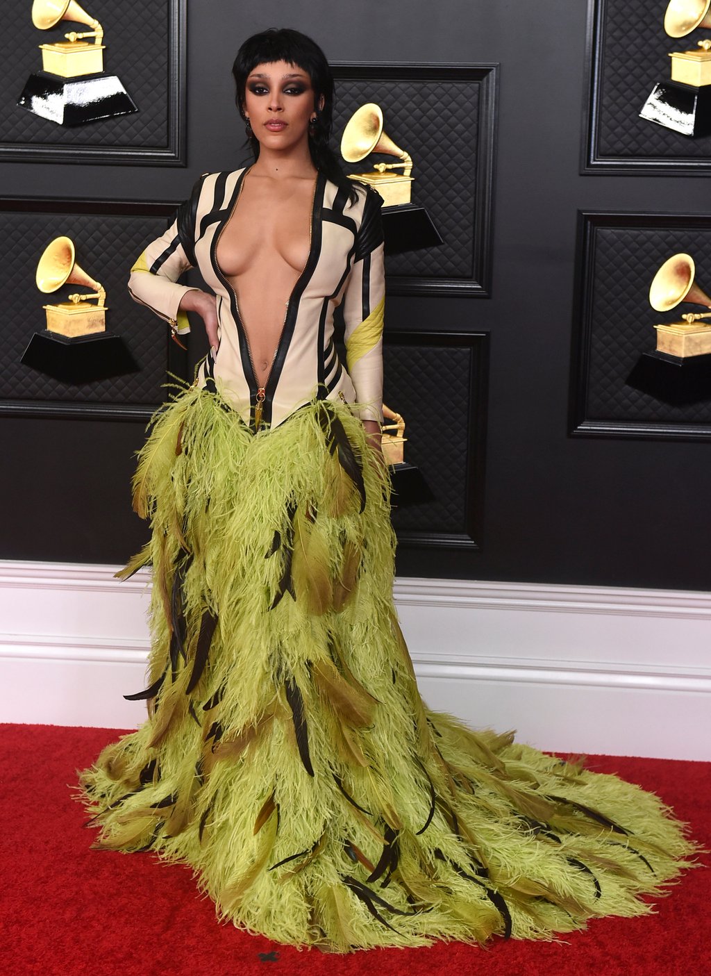 14 outfits that prove Doja Cat is 2023 s quirkiest style icon from covering herself in red Swarovski crystals and wearing a Vivienne Westwood chair hat to that Thom Browne worm dress