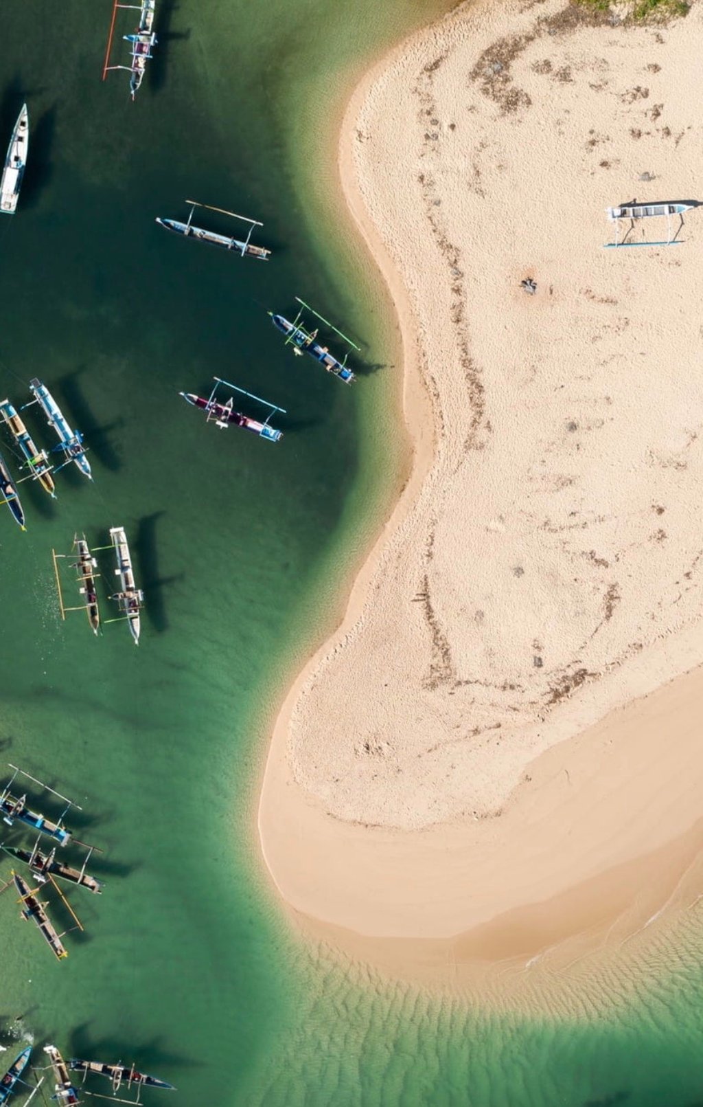 A bird’s-eye view of a beach on Sumba, an hour’s flight from Bali – with boats floating in the emerald green waters that surround the island. Photo: Cap Karoso A bird’s-eye view of a beach on Sumba, an hour’s flight from Bali – with boats floating in the emerald green waters that surround the island. Photo: Cap Karoso
