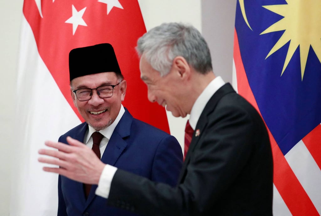 Singapore’s PM Lee Hsien Loong and his Malaysian counterpart Anwar Ibrahim after a signing ceremony at the Istana Presidential Palace in Singapore on January 30. Photo: AFP