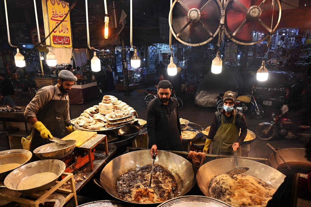 Cooks fry fish at a market in Rawalpindi. The price of many basic ingredients has practically doubled in Pakistan over the past three years. Photo: AFP Cooks fry fish at a market in Rawalpindi. The price of many basic ingredients has practically doubled in Pakistan over the past three years. Photo: AFP