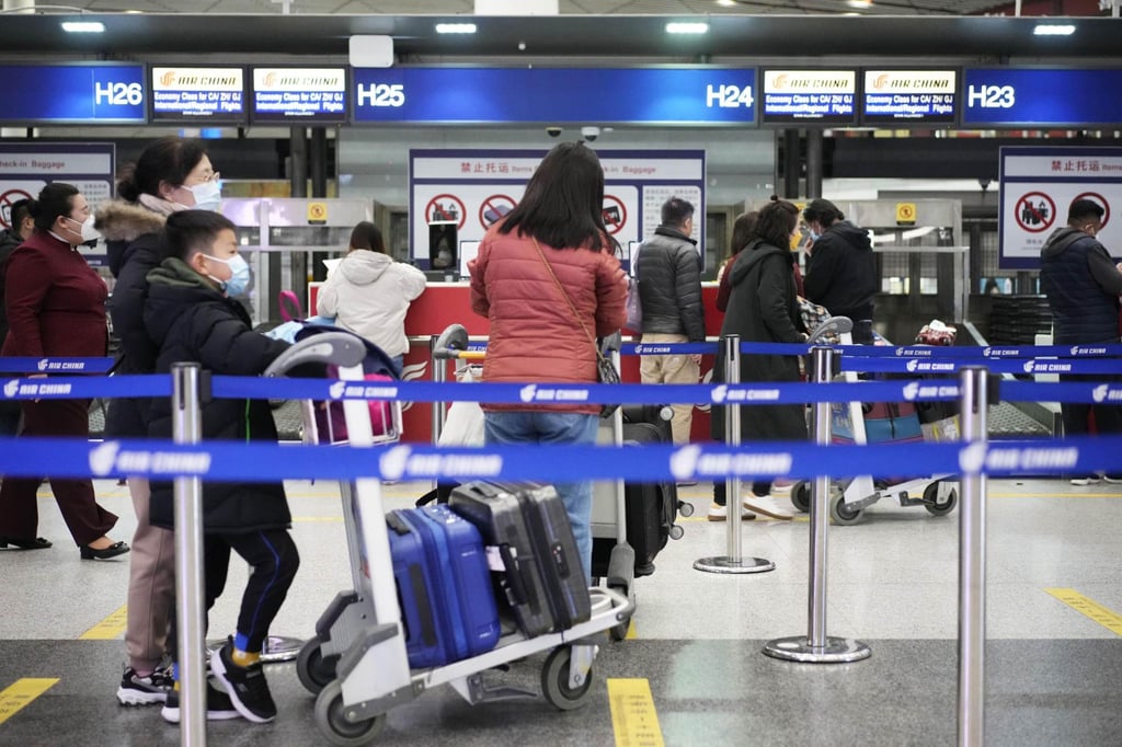 Passengers queue at baggage check-in counters at Beijing Capital International Airport on Sunday, ahead of the lifting of a Covid-related ban on overseas group tours. Photo: Kyodo Passengers queue at baggage check-in counters at Beijing Capital International Airport on Sunday, ahead of the lifting of a Covid-related ban on overseas group tours. Photo: Kyodo
