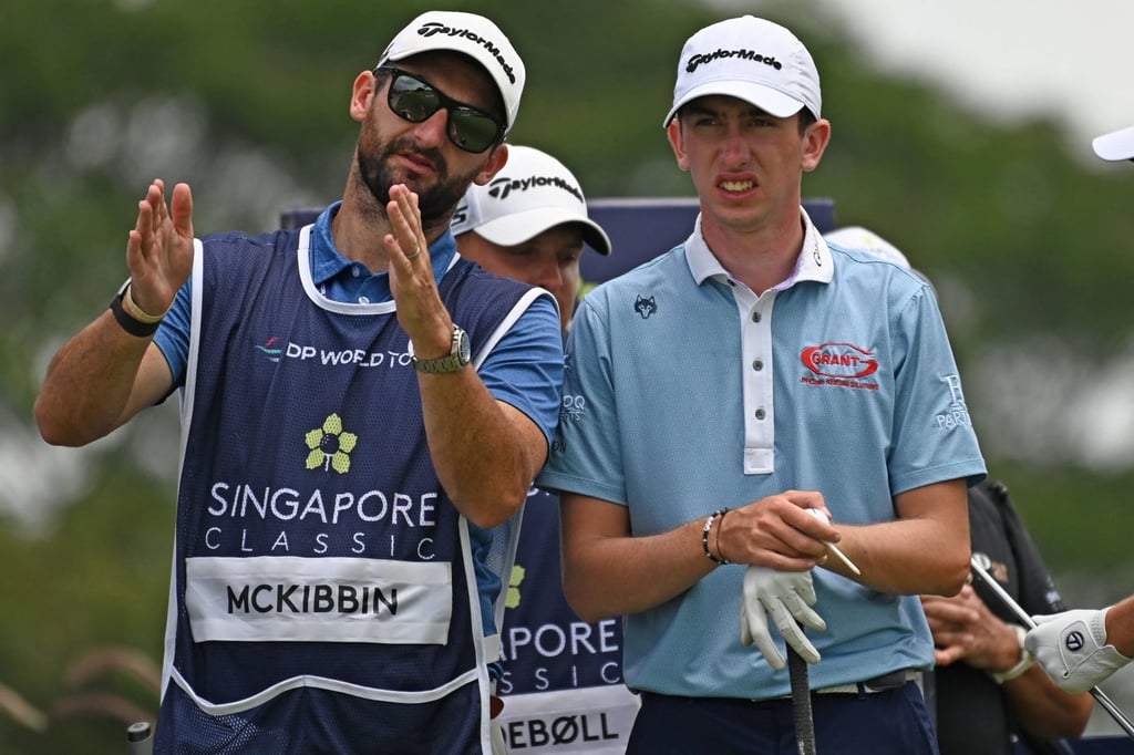 Tom McKibbin (right) listens to his caddy at Laguna National Resort Golf Club. Photo: AFP