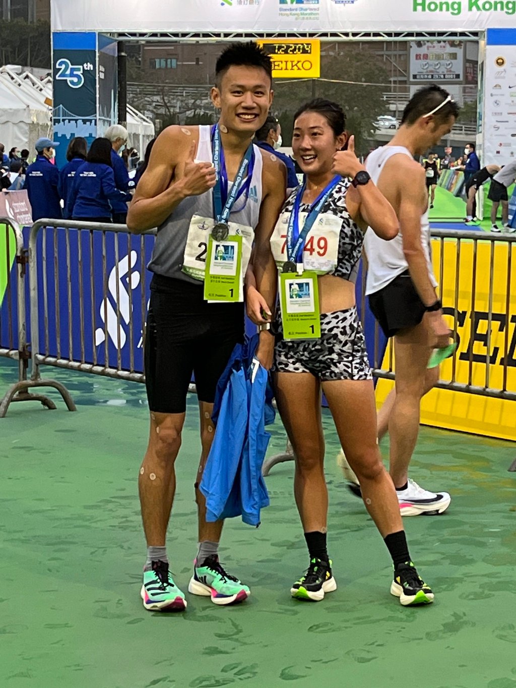 Eric Wong and Virginia Lo at the finish area for the 25th Standard Chartered Hong Kong Marathon. Photo: Shirley Chiu