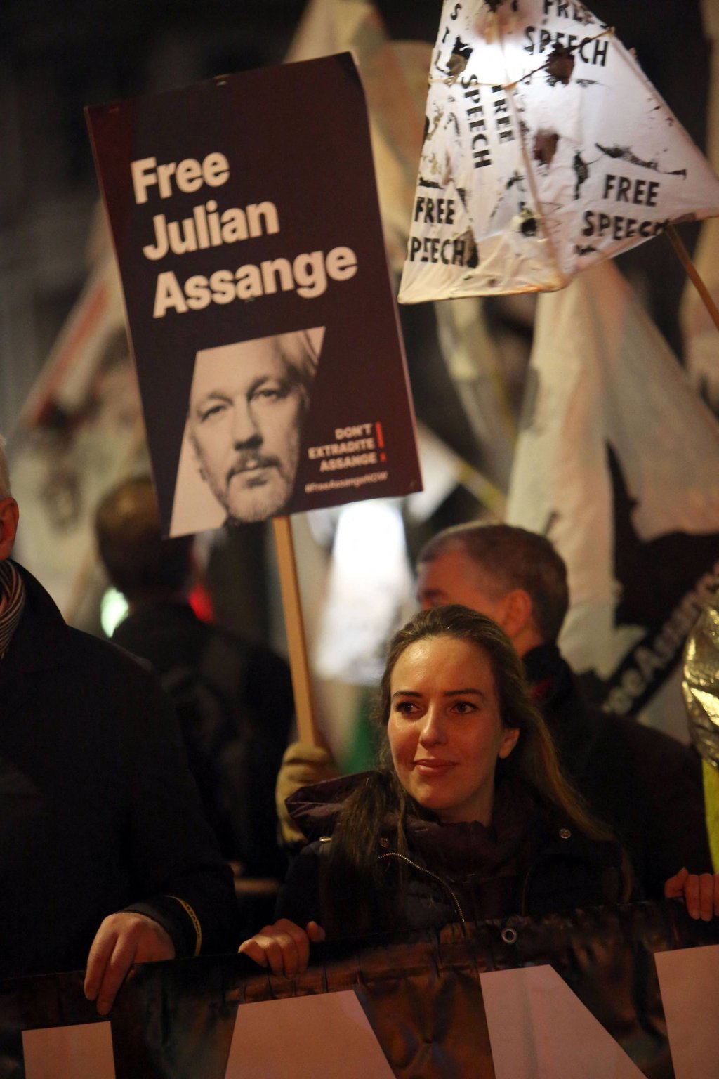 Stella Assange, wife of WikiLeaks founder Julian Assange, holds a banner during a Night Carnival for Assange march in London on Saturday. Photo: AFP
