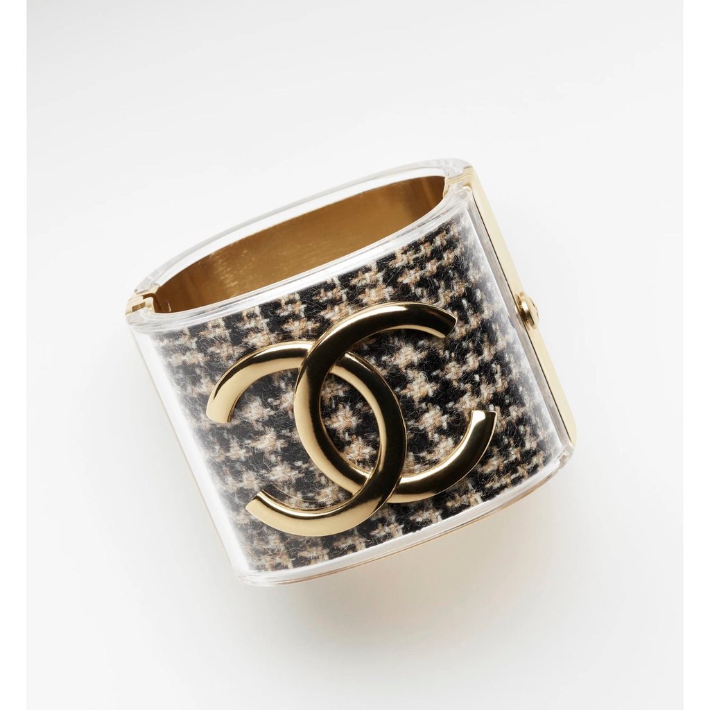 Chanel’s cuff made from resin and metal, in tweed gold, beige and black. Photo: Chanel Chanel’s cuff made from resin and metal, in tweed gold, beige and black. Photo: Chanel