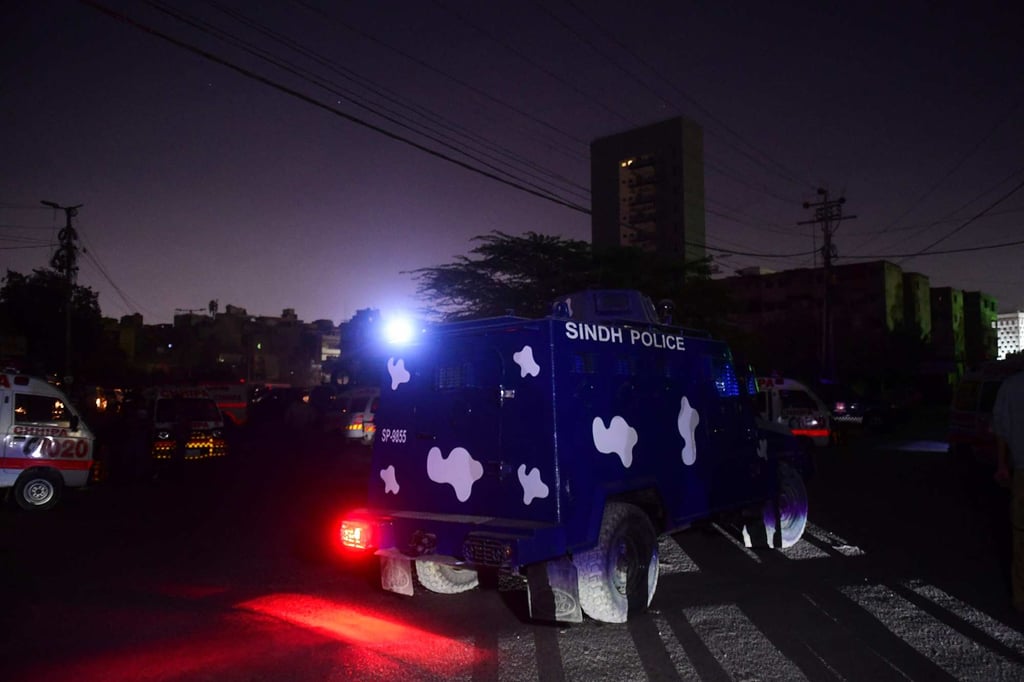 Security staff and ambulances are seen near the site of an attack on a police compound in Karachi, Pakistan on Friday. Photo: AFP Security staff and ambulances are seen near the site of an attack on a police compound in Karachi, Pakistan on Friday. Photo: AFP