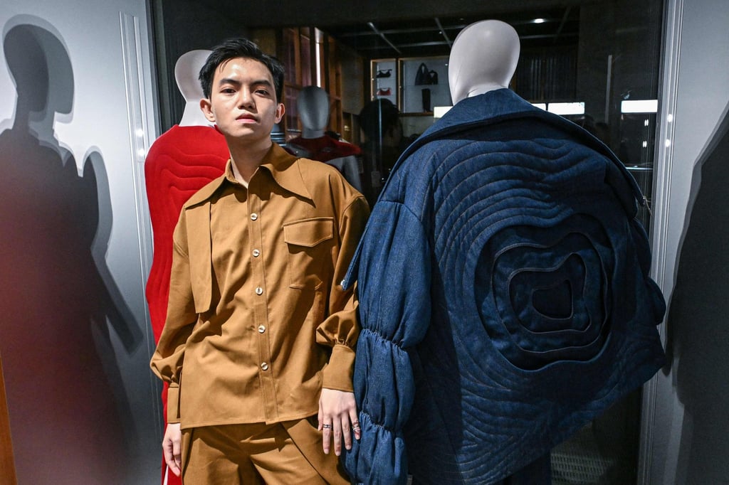Vietnamese-born fashion designer Phan Dang Hoang poses next to his creations at the Afrofashion at Modes event during the Fashion Week in Milan on February 22. Photo: AFP