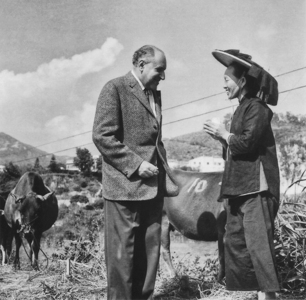 Lawrence Kadoorie, one of the brothers behind the Kadoorie Agricultural Aid Association set up to help farmers, speaks to a villager working the fields in Hong Kong in the early 1960s. Photo: SCMP