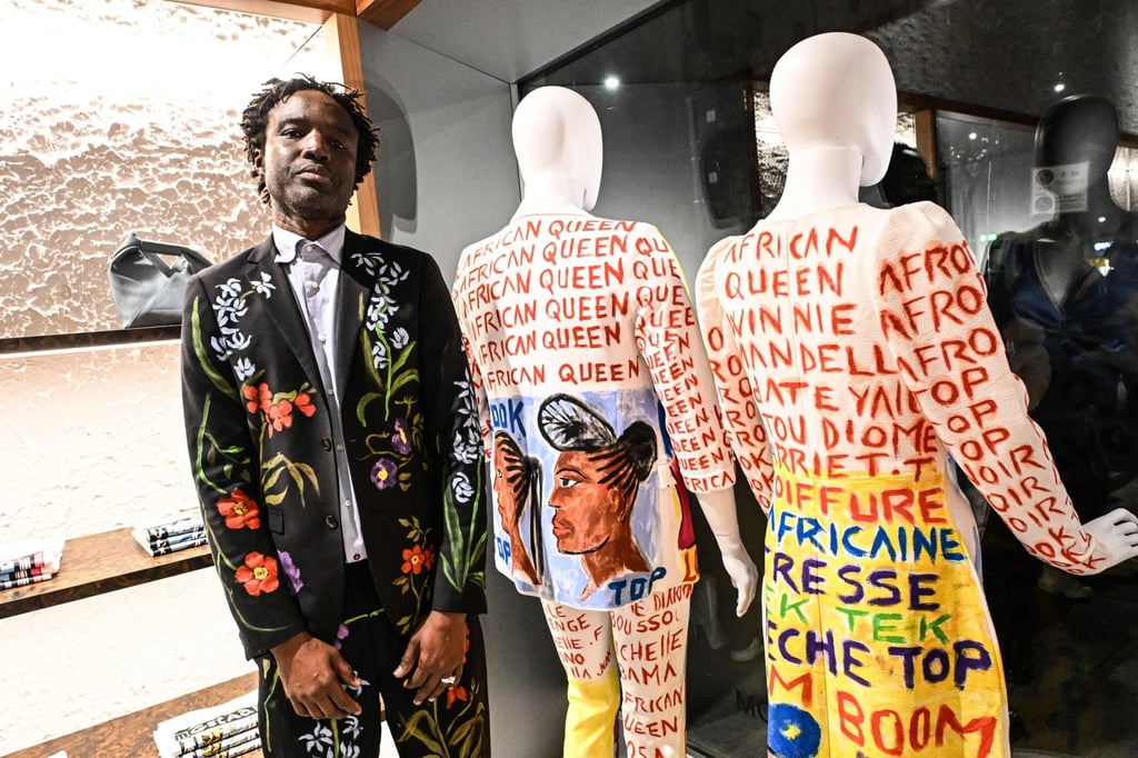 Senegalese painter and fashion designer Mokodu Fall poses next to creations at the Afrofashion at Modes event during the Fashion Week in Milan on February 22. Photo: AFP