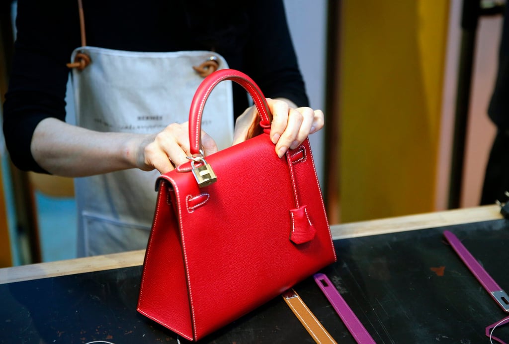 A craftswoman works on a Hermès Kelly handbag during an event in Paris on November 23, 2016. Photo: Chesnot/Getty Images