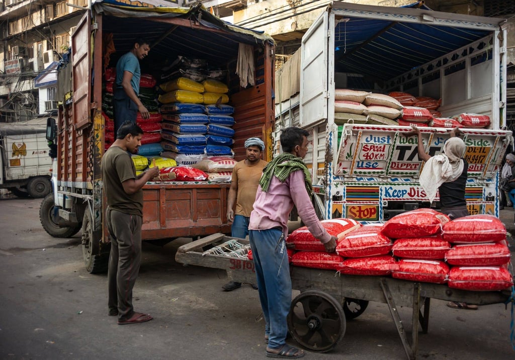 Workers load sacks of flour onto trucks at a market in New Delhi, India, on Sunday. Photo: Bloomberg Workers load sacks of flour onto trucks at a market in New Delhi, India, on Sunday. Photo: Bloomberg