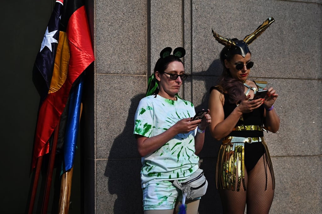 People wearing fancy dress looks at their phones during a pride parade in Sydney last month. Australian security agencies hadn’t recommended a TikTok ban ‘to date’, the country’s treasurer said. Photo: EPA-EFE