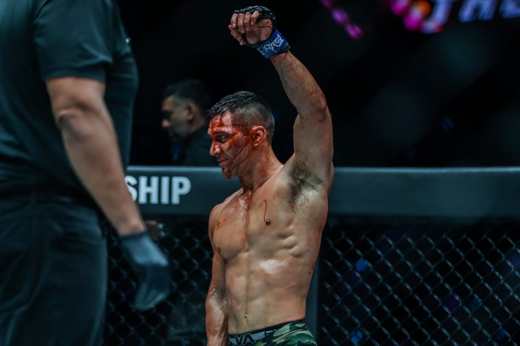 Lowen Tynanes raises his hand after a bloody fight with Dae Sung-park.