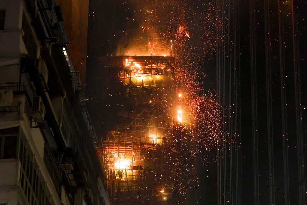 Burning embers and debris rain down on the streets below. Photo: Edmond So