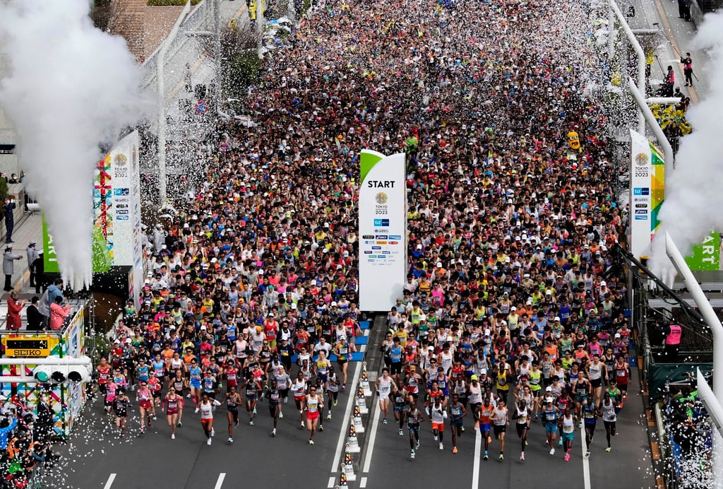 Runners fill the street in front of the Tokyo Metropolitan Government Building for the start of the marathon. Photo: AP