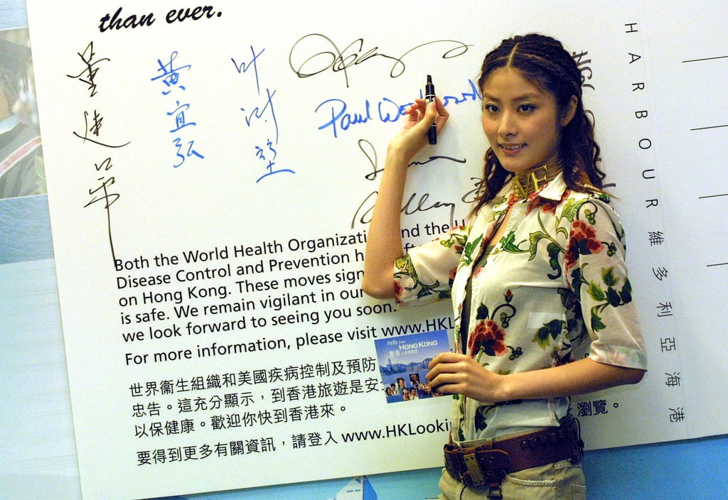 Hong Kong singer Kelly Chen signs a giant postcard during the launch of a “Hello from Hong Kong” postcard campaign to boost tourism to Hong Kong in 2003, an initiative to convince the world the Sars virus had been contained and the city was safe to visit. Recently a post-Covid-19 “Hello Hong Kong” campaign began. Photo: AFP Hong Kong singer Kelly Chen signs a giant postcard during the launch of a “Hello from Hong Kong” postcard campaign to boost tourism to Hong Kong in 2003, an initiative to convince the world the Sars virus had been contained and the city was safe to visit. Recently a post-Covid-19 “Hello Hong Kong” campaign began. Photo: AFP