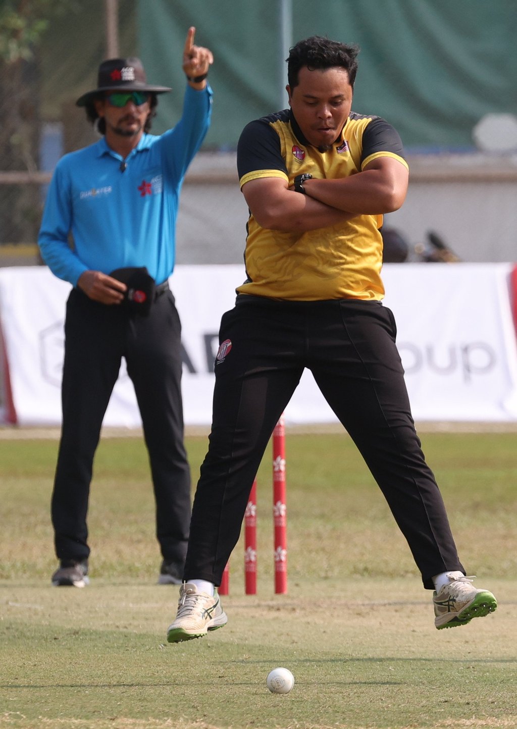 Malaysia’s Muhammad Fitri Mohs Sham celebrates a wicket.