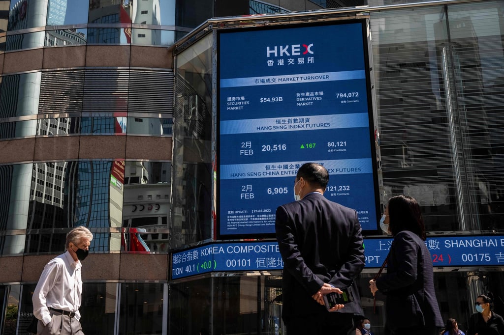 People walk through Exchange Square outside the Hong Kong stock exchange on February 23. Photo: AFP People walk through Exchange Square outside the Hong Kong stock exchange on February 23. Photo: AFP