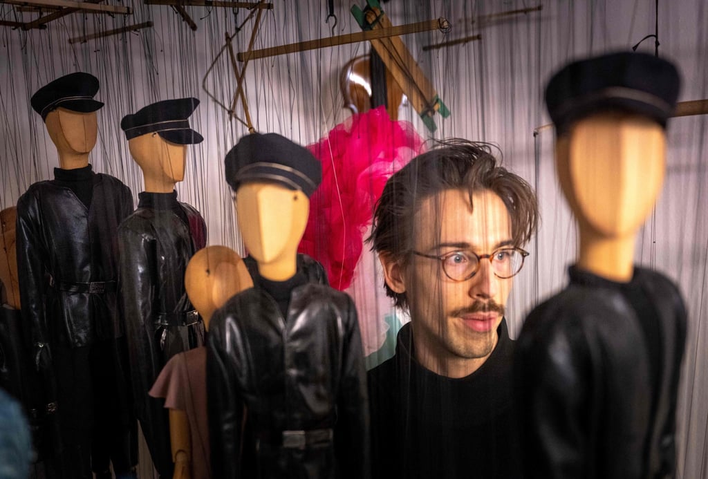 Puppeteer Edouard Funck is seen with faceless puppets prior to the Snow White fairy tale puppet show at the Salzburg Marionette Theatre in Salzburg, Austria, in February 2023. Photo: AFP