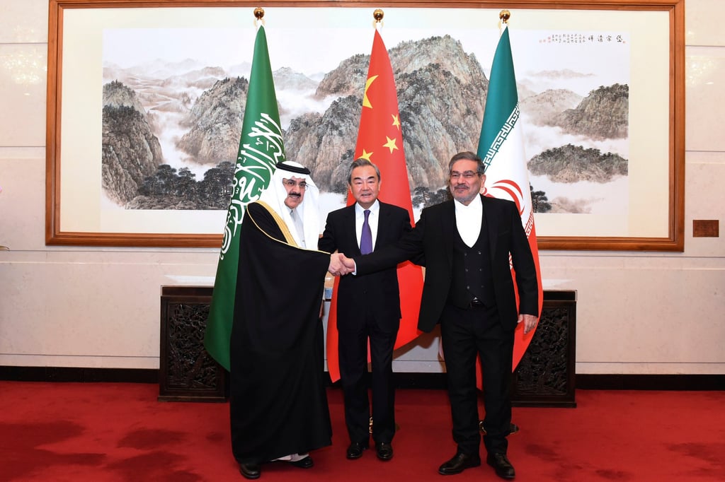 Saudi Arabian national security adviser Musaad bin Mohammed Al-Aiban (left) shakes hands with Ali Shamkhani, secretary of Iran’s Supreme National Security Council, as China’s top diplomat Wang Yi looks on, in Beijing on March 11. Photo: Xinhua