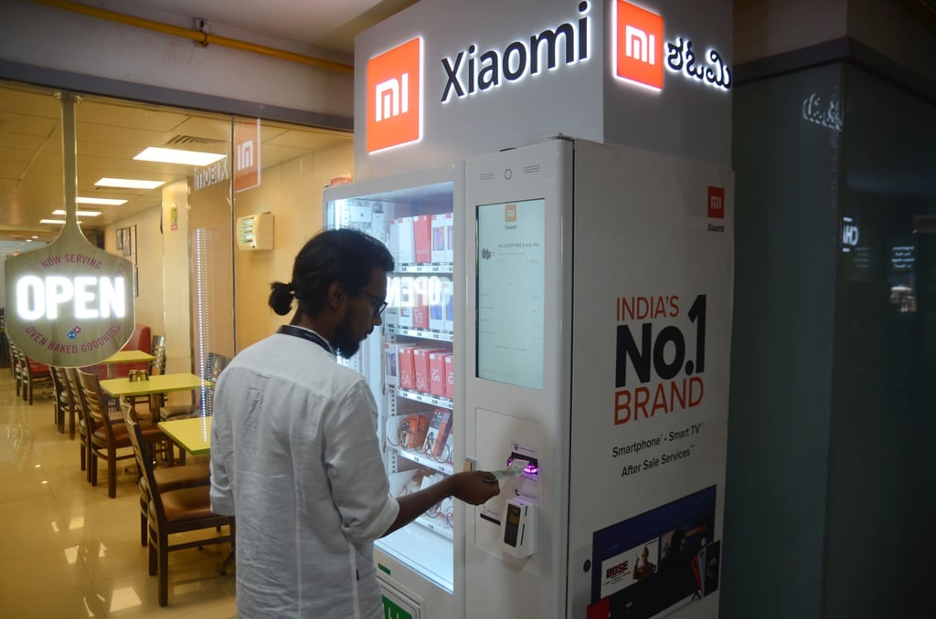 A man uses a Xiaomi vending machine in Bangalore. Xiaomi and BBK Electronics’ Vivo and Oppo account for 47 per cent of total smartphone sales in India. Photo: Xinhua