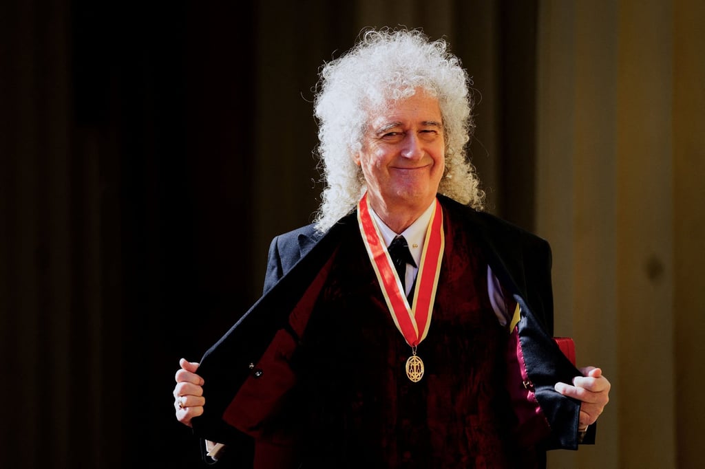 British musician Brian May poses with his medal after being knighted during an investiture ceremony at Buckingham Palace in London on Tuesday. Photo: AFP / Getty Images / TNS