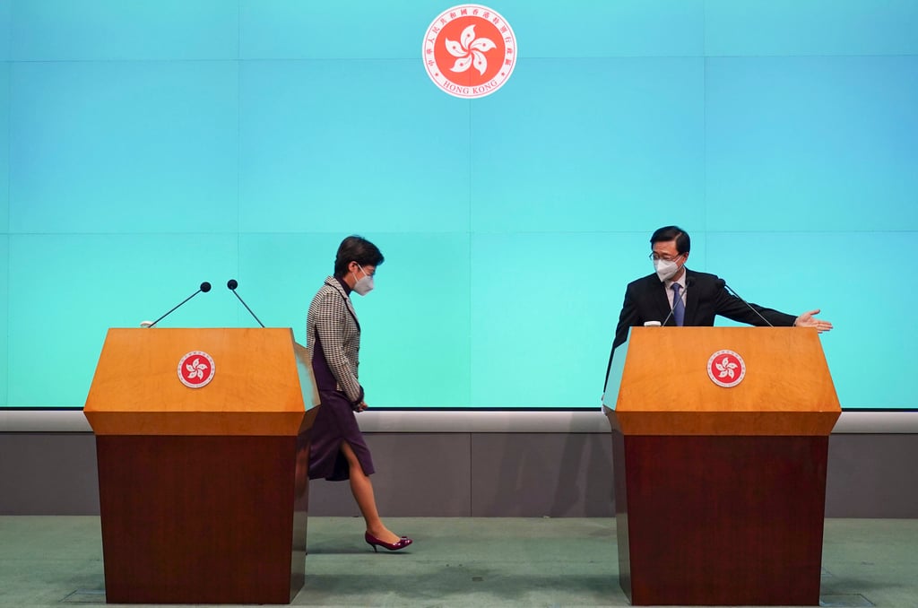 Hong Kong’s Chief Executive-elect John Lee Ka-chiu (right) showing the exit to his predecessor Carrie Lam Cheng Yuet-ngor (left) during a joint press conference on 9 May 2022. This photograph won the Merit 1 award in the Best Photograph (News) award for Robert Ng. Photo: Robert Ng Hong Kong’s Chief Executive-elect John Lee Ka-chiu (right) showing the exit to his predecessor Carrie Lam Cheng Yuet-ngor (left) during a joint press conference on 9 May 2022. This photograph won the Merit 1 award in the Best Photograph (News) award for Robert Ng. Photo: Robert Ng