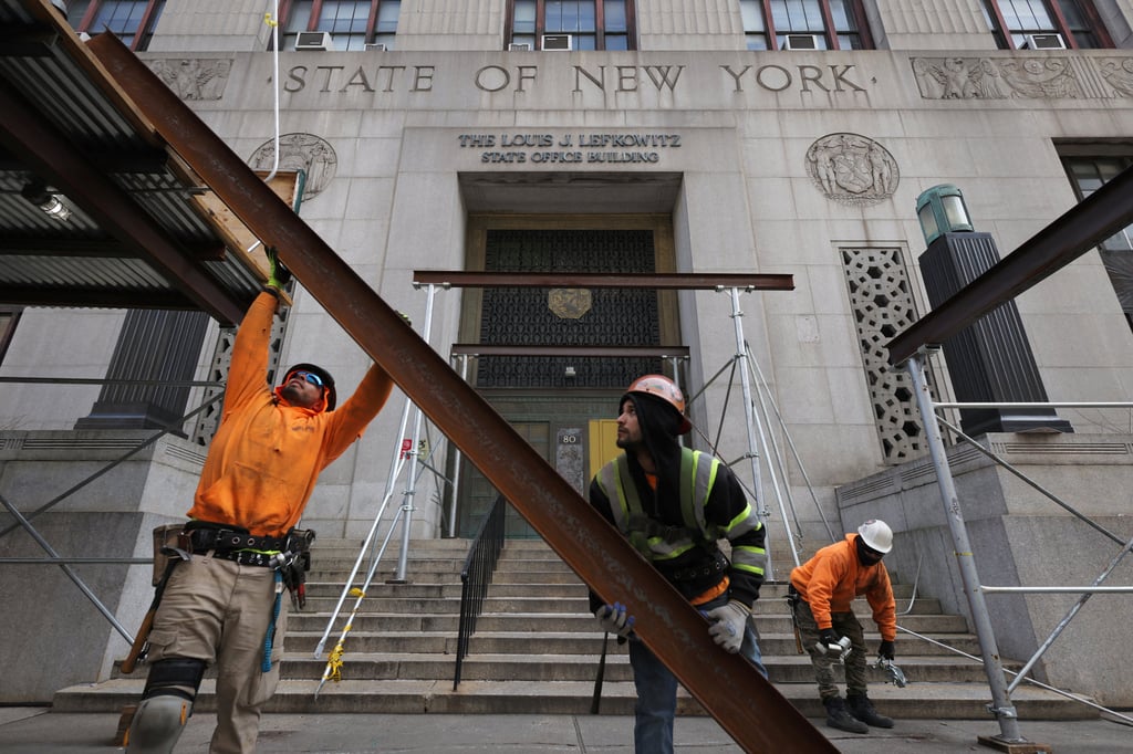 Workers remove scaffolding at the New York Courthouse where Manhattan District Attorney Alvin Bragg continues his investigation into Donald Trump in Manhattan, New York on Saturday. Photo: Reuters