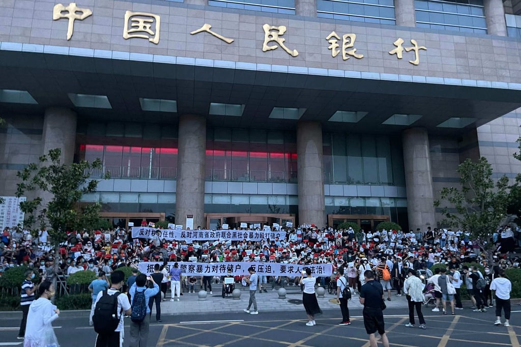 People protesting in front of a branch of the People’s Bank of China in Zhengzhou, the capital of Henan province, in July 2022. Photo: Handout via AFP People protesting in front of a branch of the People’s Bank of China in Zhengzhou, the capital of Henan province, in July 2022. Photo: Handout via AFP