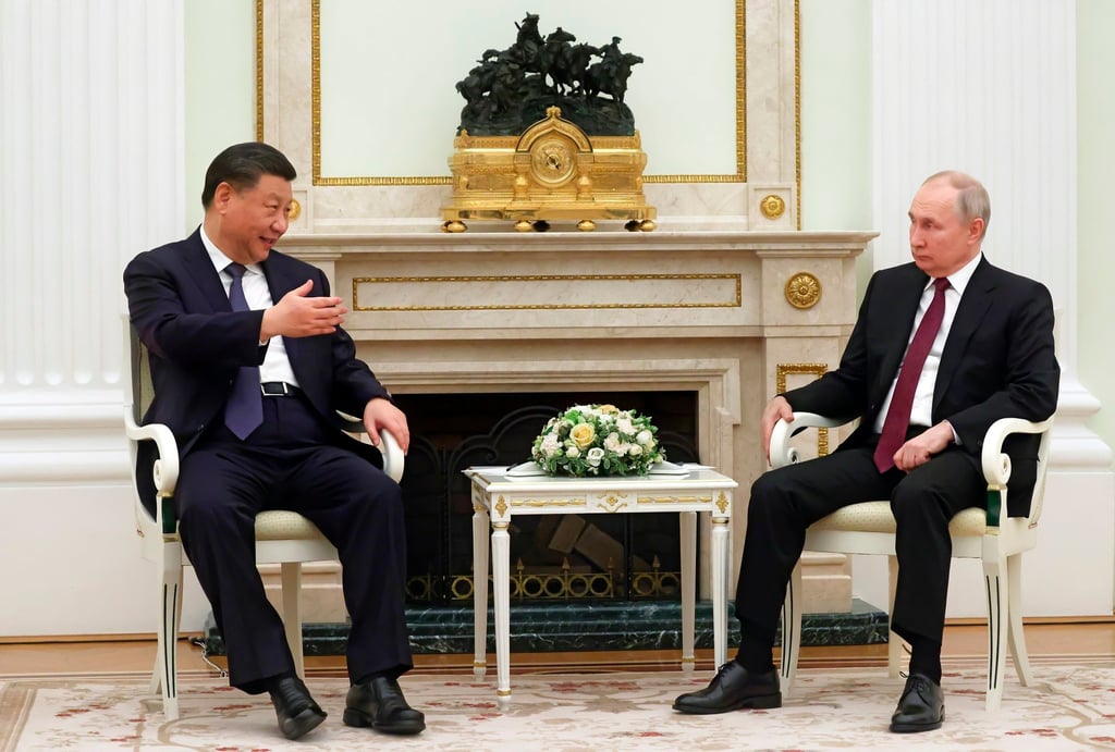 Chinese President Xi Jinping speaks with Russian leader Vladimir Putin during their meeting at the Kremlin on Monday. Photo: Kremlin Pool Photo via AP
