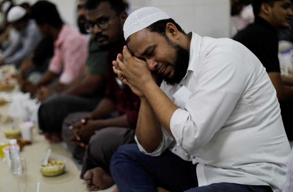 A man reacts as he prays before breaking fast on the first day of Ramadan in Kuala Lumpur on Thursday. Photo: Reuters