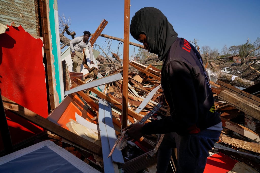 The son and nephew of Cedric Miles search for belongings inside the Miles family home after thunderstorms spawning high straight-line winds and tornadoes ripped across the state in Rolling Fork, Mississippi. Photo: Reuters The son and nephew of Cedric Miles search for belongings inside the Miles family home after thunderstorms spawning high straight-line winds and tornadoes ripped across the state in Rolling Fork, Mississippi. Photo: Reuters