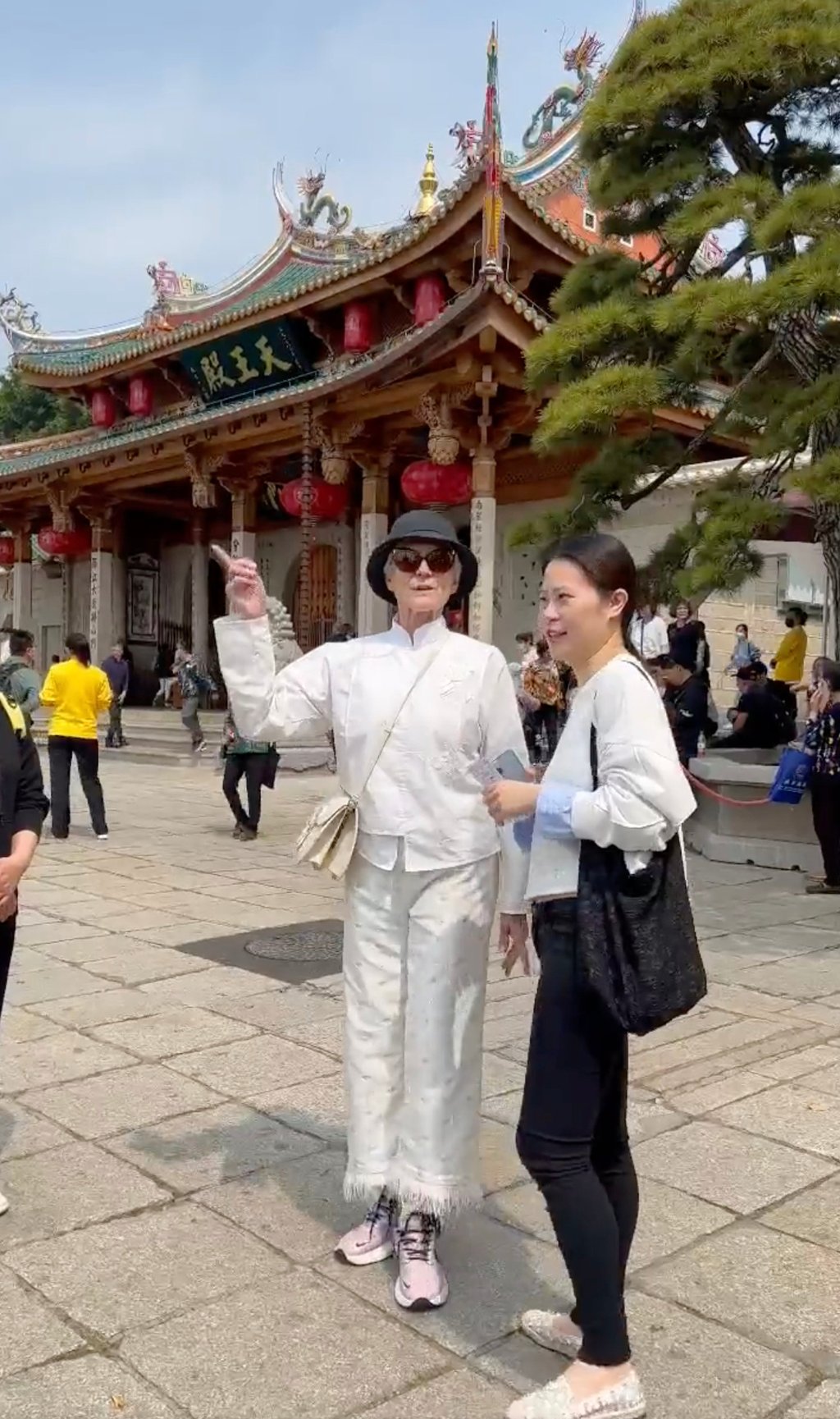 Taking in the sights: Maye Musk with her tour guide outside a temple during her visit to China. Photo: Twitter@mayemusk Taking in the sights: Maye Musk with her tour guide outside a temple during her visit to China. Photo: Twitter@mayemusk
