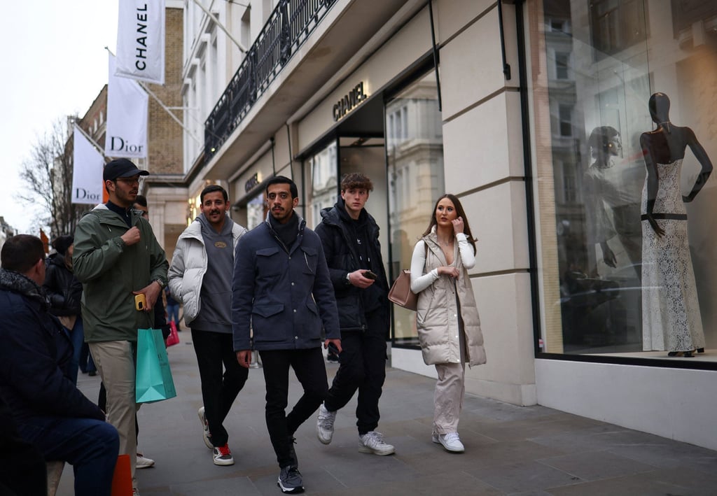People walk outside a Chanel store on New Bond Street in London, Britain. Photo: Reuters