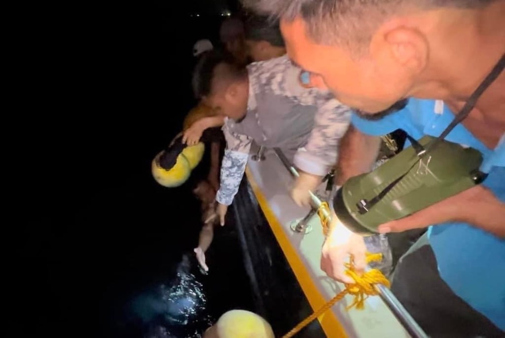 Philippine coastguard personnel pulling a survivor from the water. Photo: EPA-EFE/PCG