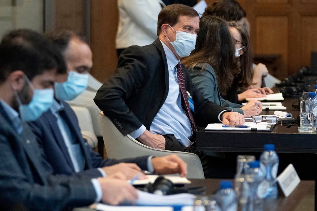 Iran’s agent Tavakol Habibzadeh (second left), US agent Richard Visek (in focus) and delegation members wait for judges to enter the International Court of Justice in The Hague on Thursday. Photo: AP