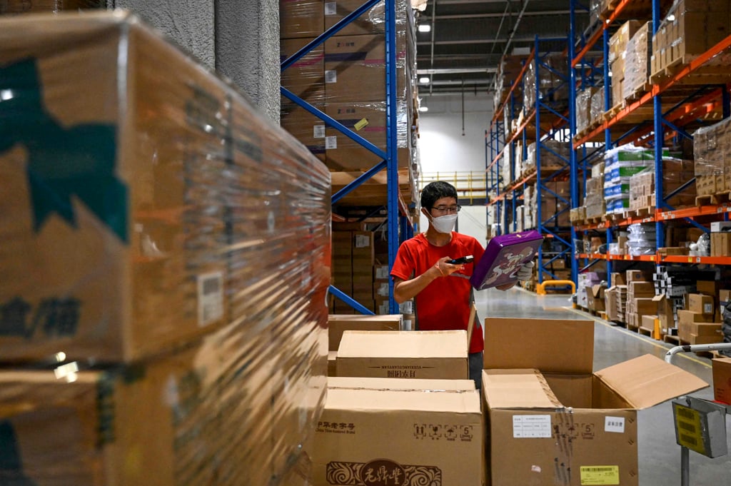 A worker sorts packages for delivery at a JD.com warehouse in Beijing. Photo: AFP A worker sorts packages for delivery at a JD.com warehouse in Beijing. Photo: AFP