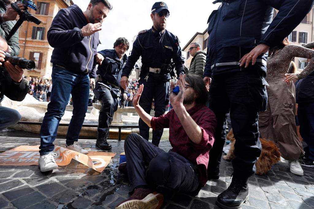 Police detain an activist from the Last Generation environmental group at the Barcaccia fountain in Piazza di Spagna, Rome, Italy on Saturday. Photo: EPA-EFE Police detain an activist from the Last Generation environmental group at the Barcaccia fountain in Piazza di Spagna, Rome, Italy on Saturday. Photo: EPA-EFE