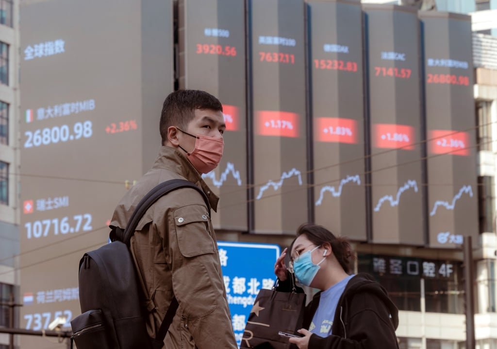 People walk on the street near a large screen showing stock-exchange data in Shanghai on March 15, 2023. Photo: EPA-EFE People walk on the street near a large screen showing stock-exchange data in Shanghai on March 15, 2023. Photo: EPA-EFE