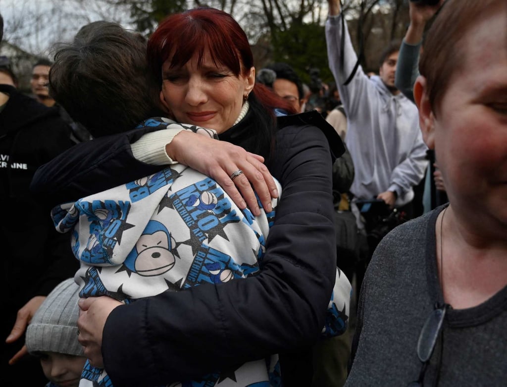 A woman hugs her son after the bus delivering him and more than a dozen other children back from Russian-held territory arrived in Kyiv in March. Photo: AFP A woman hugs her son after the bus delivering him and more than a dozen other children back from Russian-held territory arrived in Kyiv in March. Photo: AFP