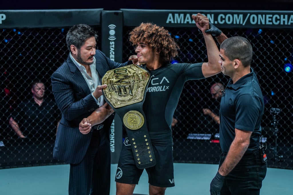 Chatri Sityodtong places the lightweight submission grappling title on Kade Ruotolo’s shoulder.