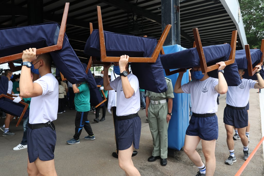 Police officers move chairs during a training session at the Hong Kong Police College in Wong Chuk Hang. Photo: Yik Yeung-man