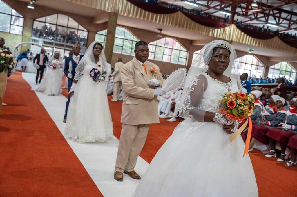 Brides and grooms at the International Pentecostal Holiness Church in Zuurbekom, south of Johannesburg, South Africa on Sunday. Photo: AFP