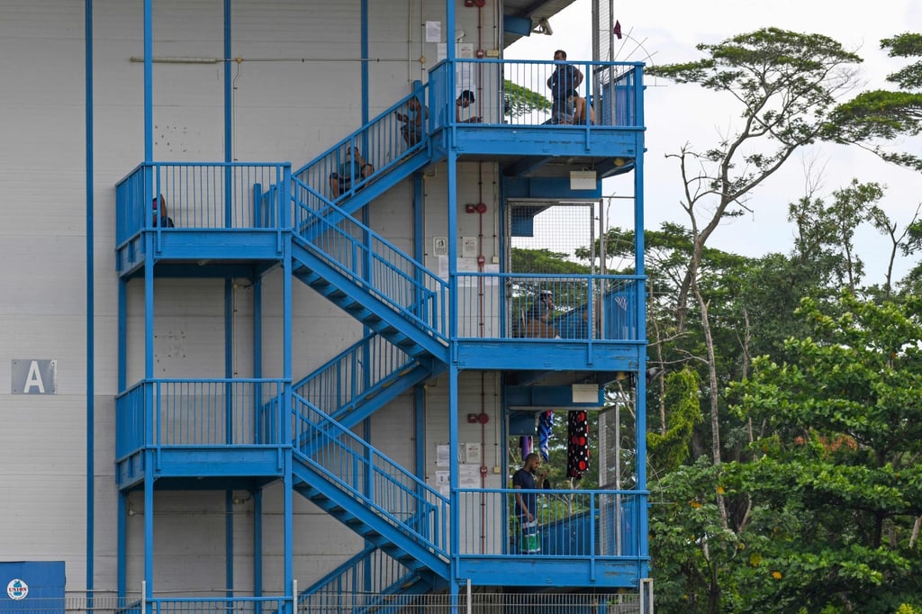 Migrant workers outside a Singapore dormitory-style accommodation block. Photo: AFP