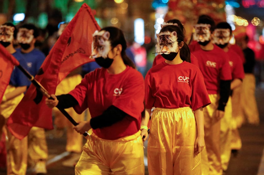 Young performers in tiger masks carry flags down Market Street as part of the annual Lunar New Year parade in San Francisco’s famed Chinatown neighbourhood on February 19, 2022. Photo: Reuters Young performers in tiger masks carry flags down Market Street as part of the annual Lunar New Year parade in San Francisco’s famed Chinatown neighbourhood on February 19, 2022. Photo: Reuters