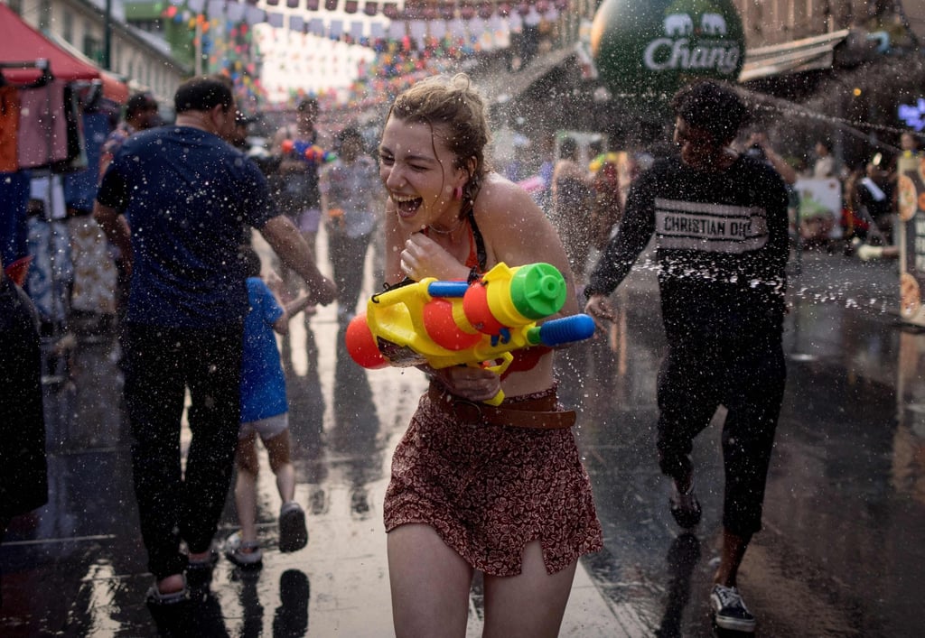 A woman is soaked as she takes part in a water fight on Khao San Road, Bangkok on the eve of Thai New Year. Photo: AFP A woman is soaked as she takes part in a water fight on Khao San Road, Bangkok on the eve of Thai New Year. Photo: AFP
