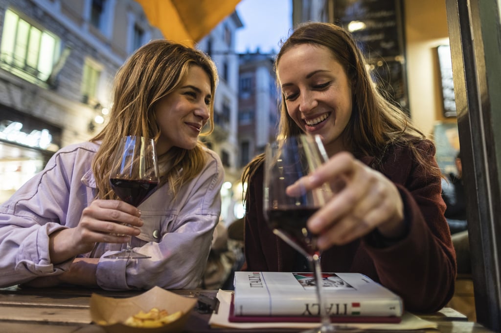 Women enjoying aperitivo in Italy. The Italian word derives from the Latin word meaning “to open”. Photo: Getty Images