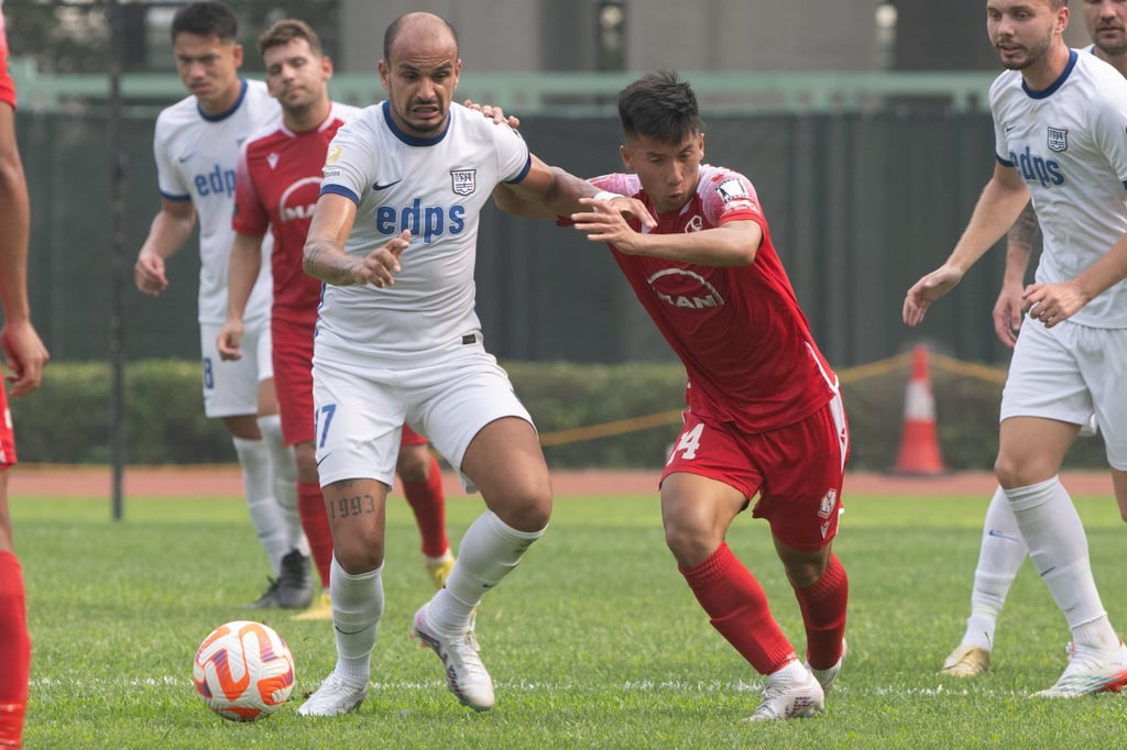 Mikael Burkatt of Kitchee vies for the ball with Ho Chun-ting of Southern. Photo: HKFA