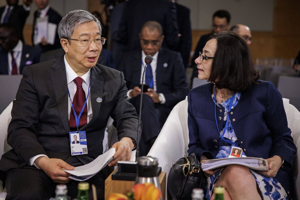 Yi speaking with Rosanna Costa, governor of the Central Bank of Chile, during the International Monetary and Financial Committee session in Washington on Friday. Photo: Bloomberg Yi speaking with Rosanna Costa, governor of the Central Bank of Chile, during the International Monetary and Financial Committee session in Washington on Friday. Photo: Bloomberg