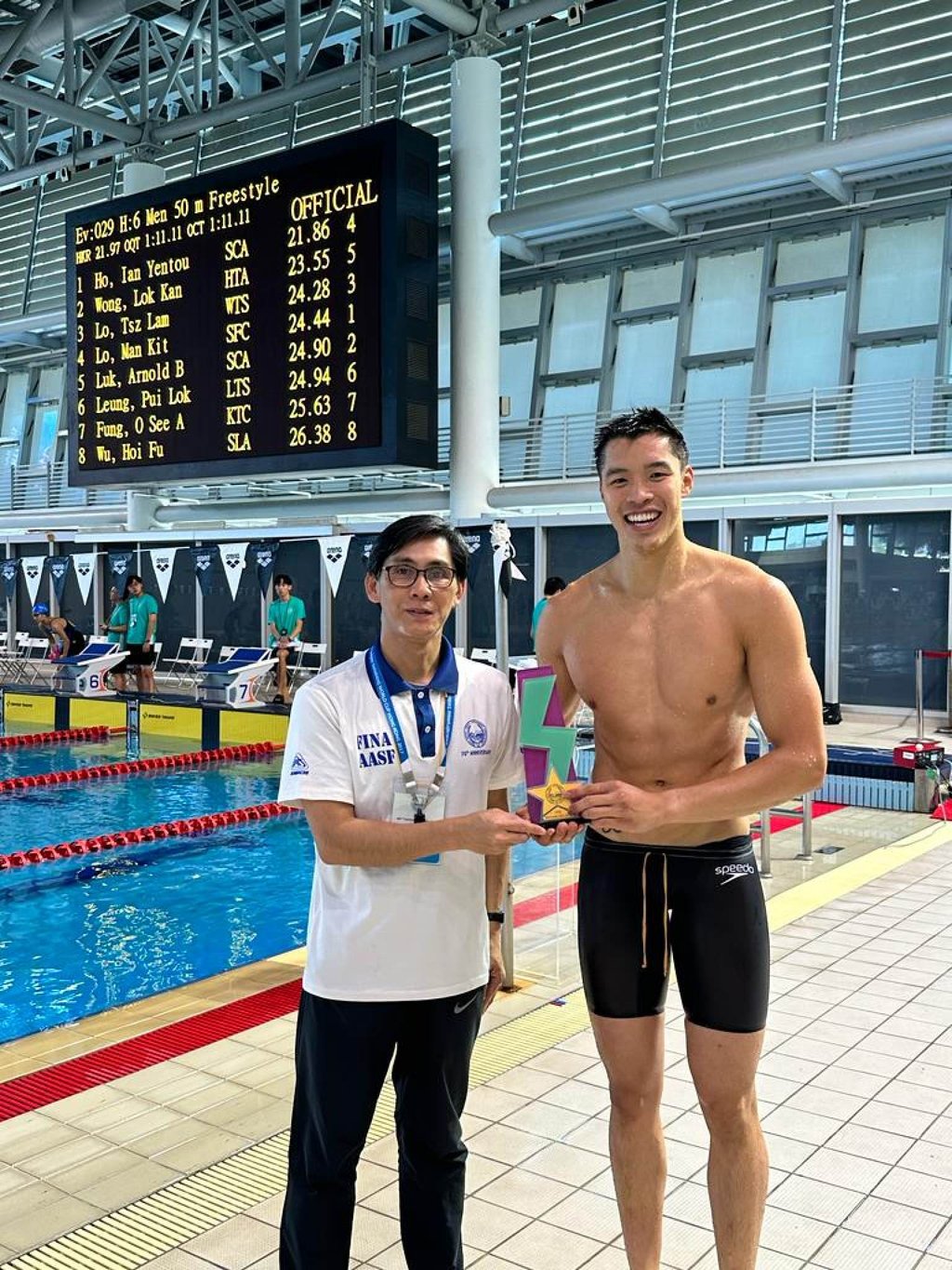Ian Ho receives trophy for breaking the Hong Kong record in the 50m freestyle at the Long Course Time Trial Championships. Photo: Handout